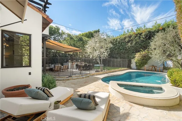 a view of a patio with a dining table and chairs with a small yard