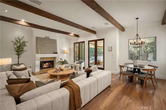 a living room with furniture wooden floor and a fireplace