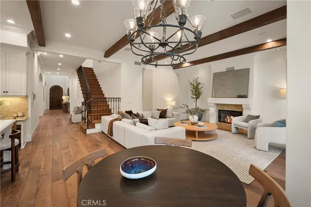 a view of a dining room with furniture a chandelier and wooden floor