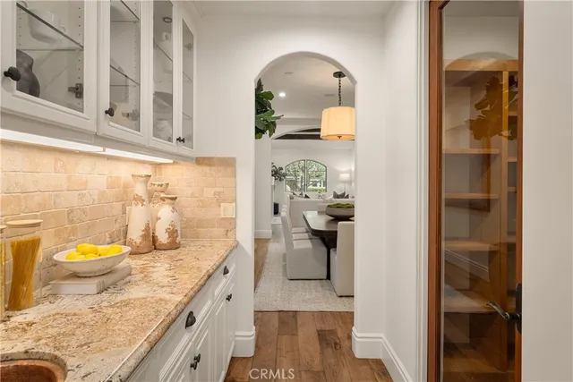 a bathroom with a granite countertop sink a toilet and shower