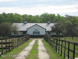 a view of a house with a wooden fence