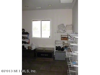 4060 South Francis Road St. Augustine, FL 32092 - Photo 11 of 25 a living room with furniture and a fireplace