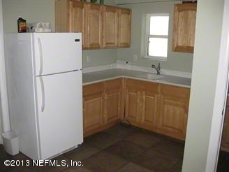 4060 South Francis Road St. Augustine, FL 32092 - Photo 18 of 25 a white refrigerator freezer sitting inside of a kitchen