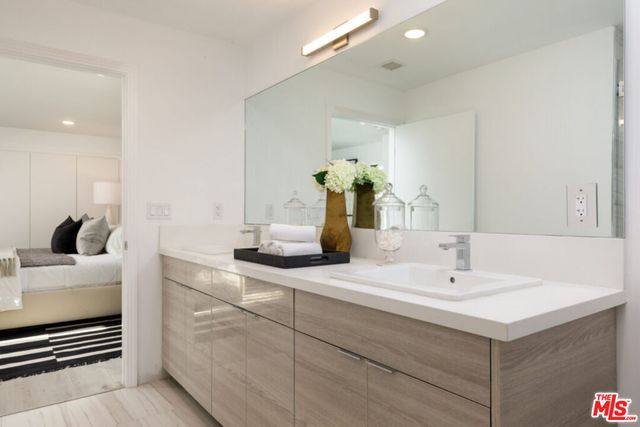 a bedroom with a bed and a mirror