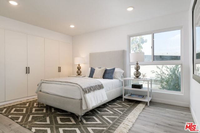 a bathroom with a bathtub shower sink vanity and toilet