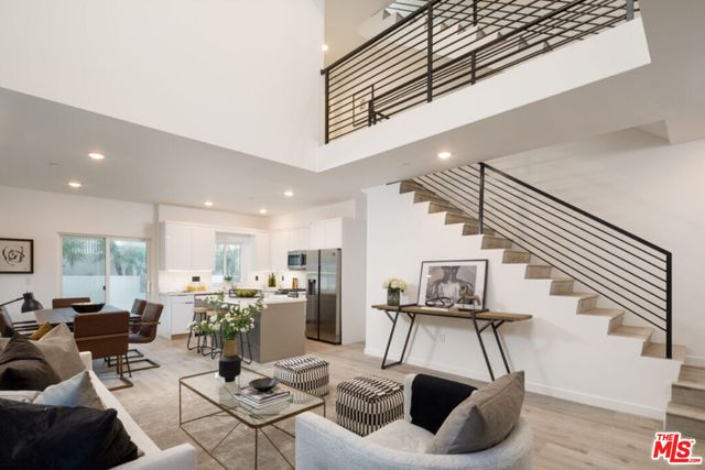 a living room with furniture and a mirror
