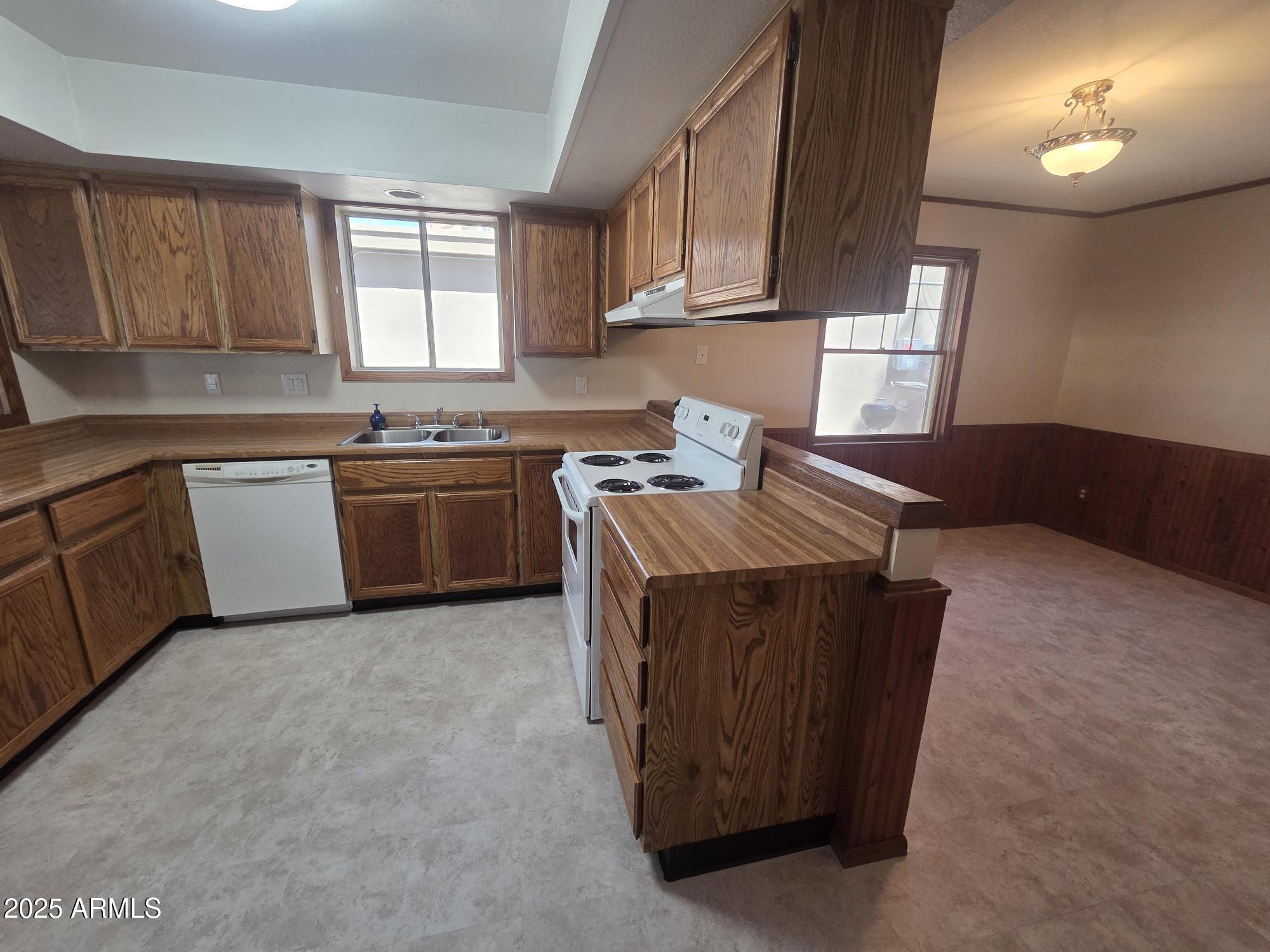 10242 East Spring Creek Road Sun Lakes, AZ 85248 - Photo 14 of 30 a kitchen with stainless steel appliances granite countertop a sink stove and cabinets