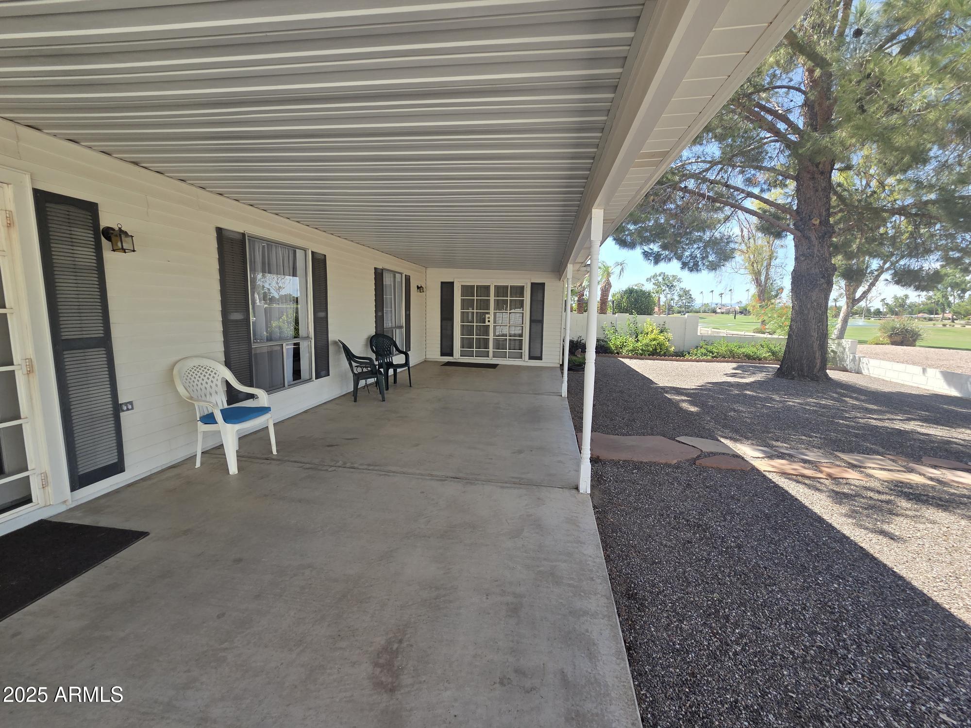 10242 East Spring Creek Road Sun Lakes, AZ 85248 - Photo 27 of 30 a view of a house with backyard and sitting area