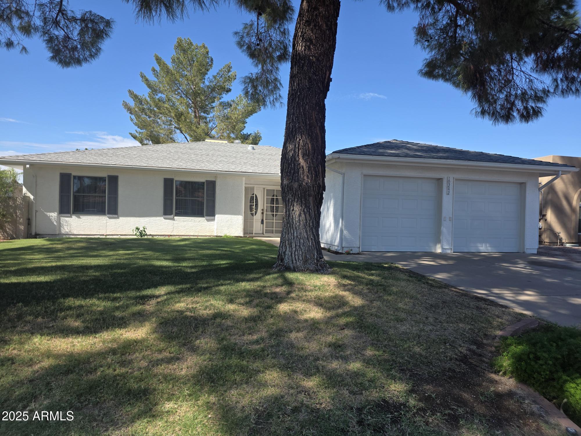 10242 East Spring Creek Road Sun Lakes, AZ 85248 - Photo 3 of 30 a front view of a house with a garden and yard