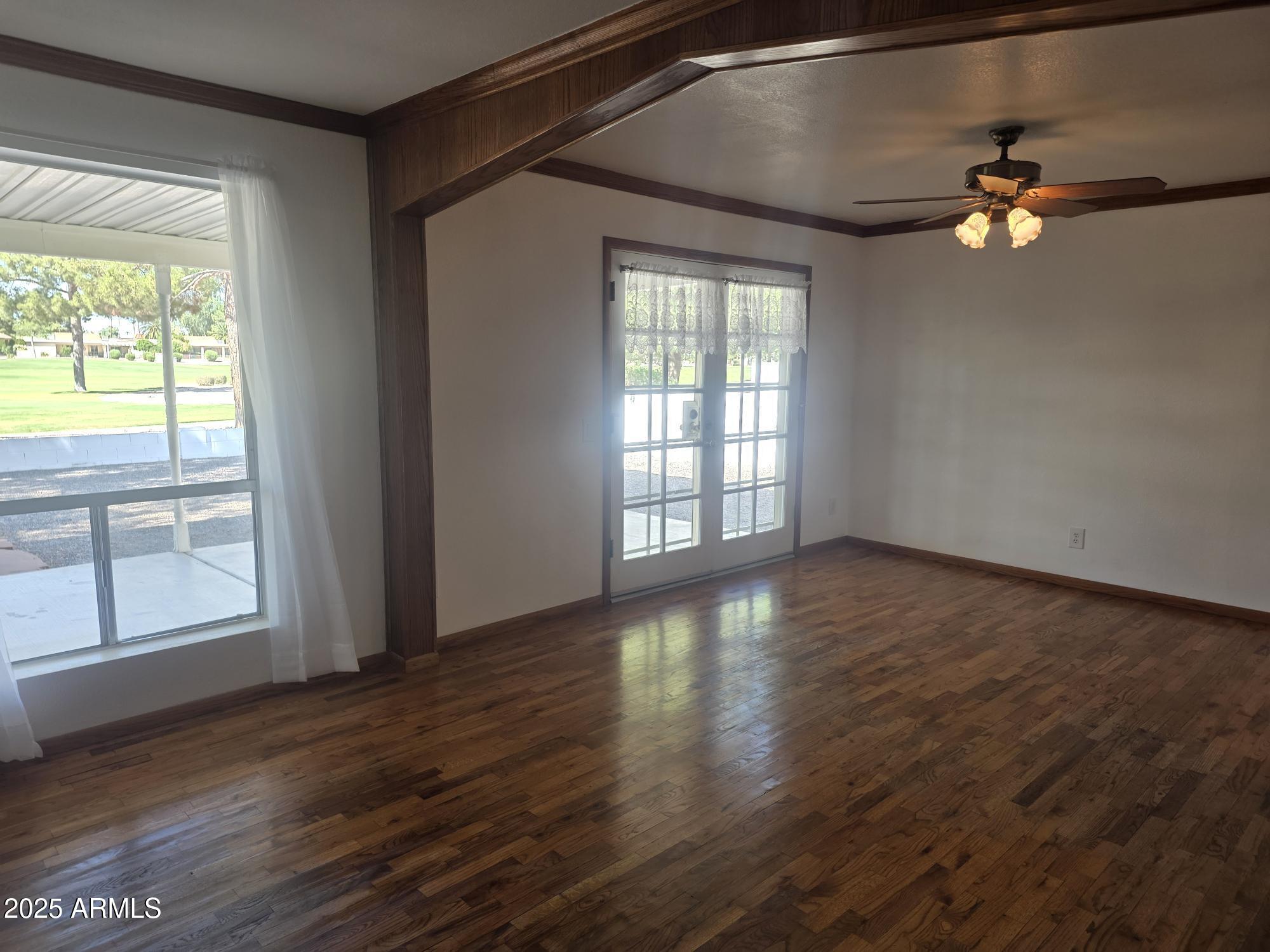 10242 East Spring Creek Road Sun Lakes, AZ 85248 - Photo 8 of 30 a view of an empty room with wooden floor and a window