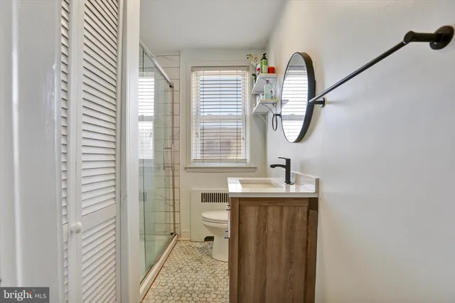 a bathroom with a sink a mirror and shower