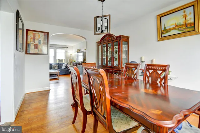 a dining room with furniture and wooden floor