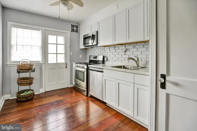 a kitchen with a refrigerator sink and cabinets