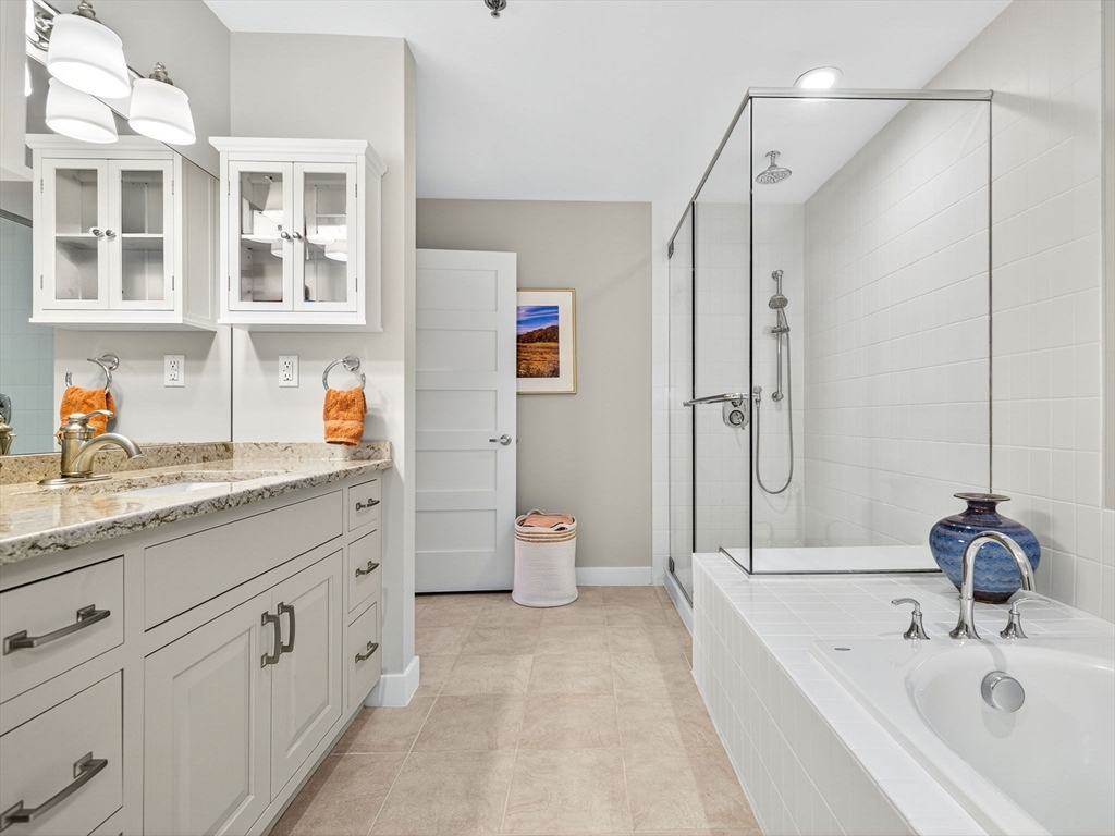 1245 Adams Street, Unit B406 Boston, MA 02124 - Photo 11 of 31 a bathroom with a tub sink and mirror