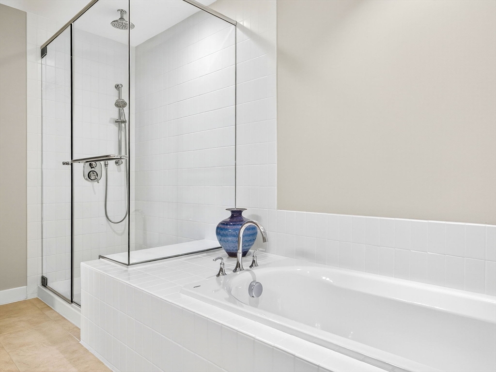 1245 Adams Street, Unit B406 Boston, MA 02124 - Photo 13 of 31 a bathroom with a bathtub and shower