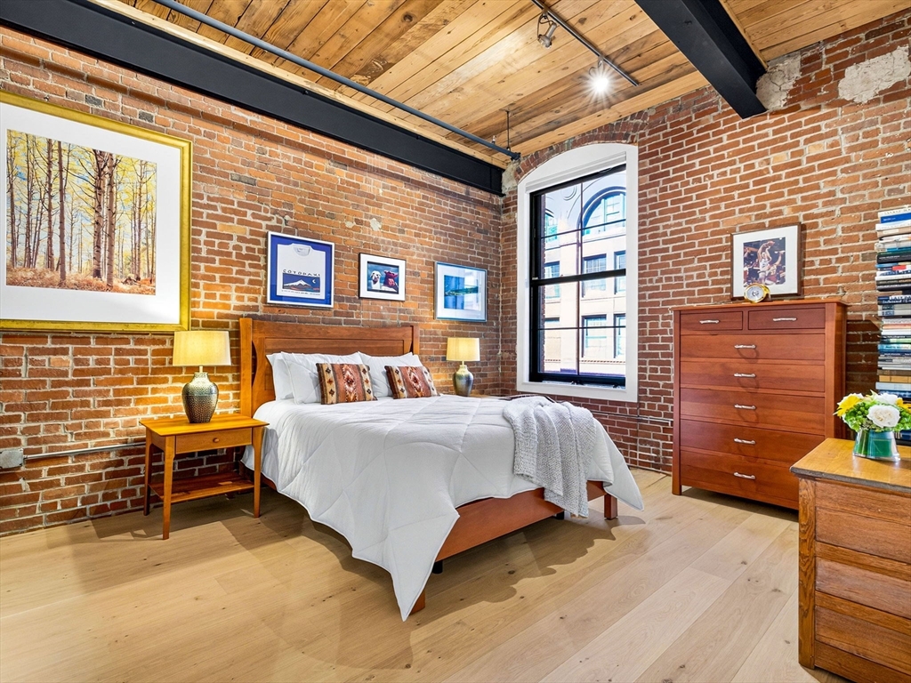 1245 Adams Street, Unit B406 Boston, MA 02124 - Photo 14 of 31 a bed sitting in front of a house