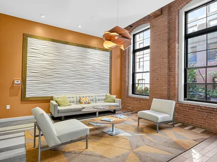 a living room with furniture and large windows