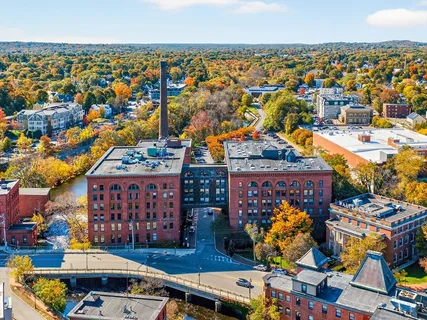 an aerial view of a building with an outdoor space and seating
