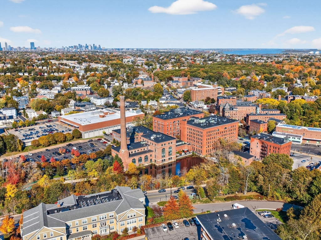 1245 Adams Street, Unit B406 Boston, MA 02124 - Photo 29 of 31 an aerial view of residential building and parking space