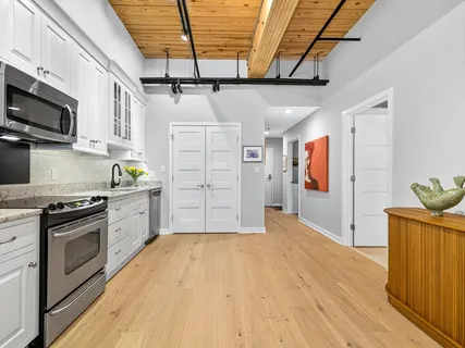 a kitchen with stainless steel appliances granite countertop a stove and a refrigerator