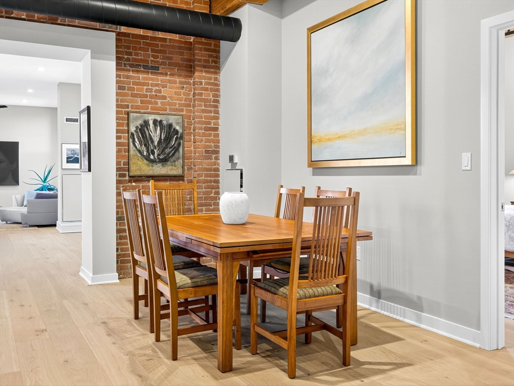 1245 Adams Street, Unit B406 Boston, MA 02124 - Photo 6 of 31 a dining room with furniture and window