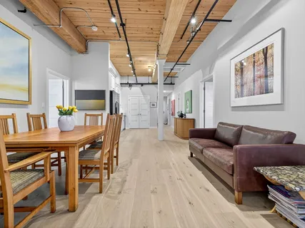a living room with furniture and a wooden floor