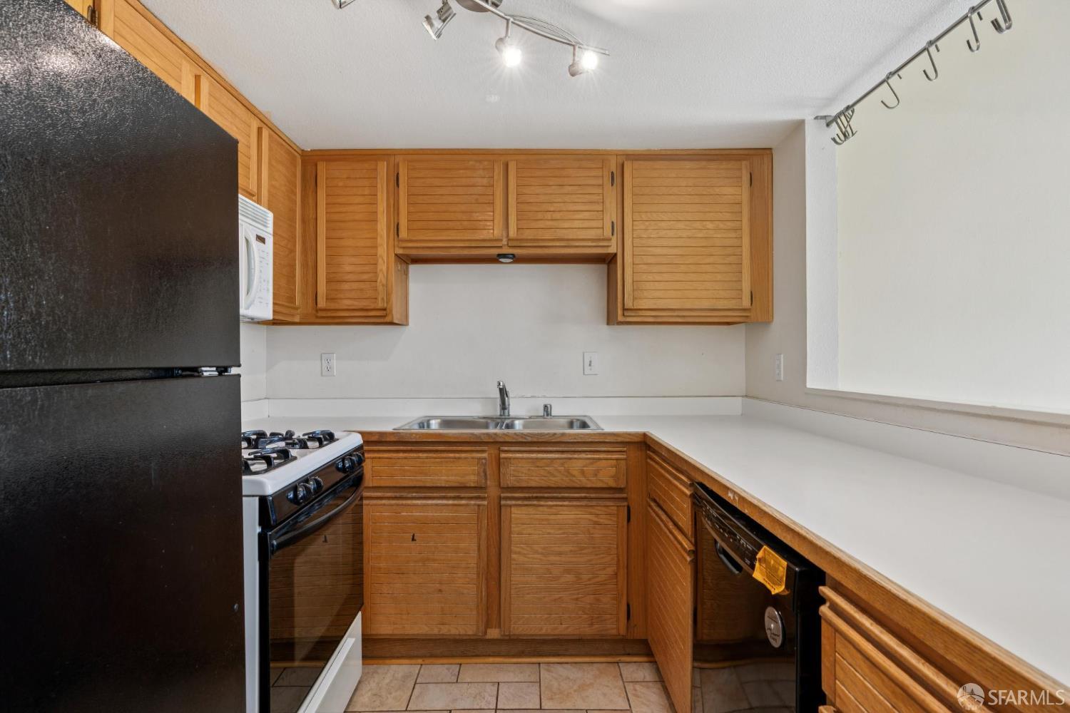 4628 Melody Drive, Unit D Concord, CA 94521 - Photo 13 of 30 a kitchen with stainless steel appliances granite countertop a sink stove and refrigerator