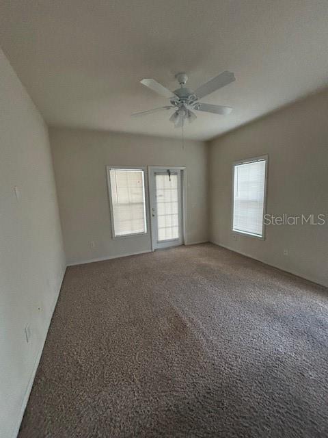 3567 Conroy Road, Unit 1225 Orlando, FL 32839 - Photo 6 of 9 a view of a big room with windows and chandelier fan