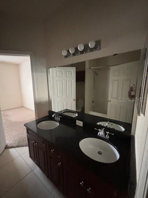 3567 Conroy Road, Unit 1225 Orlando, FL 32839 - Photo 7 of 9 a bathroom with a double vanity sink and a mirror