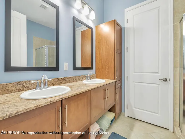 a bathroom with a glass door shower and a sink