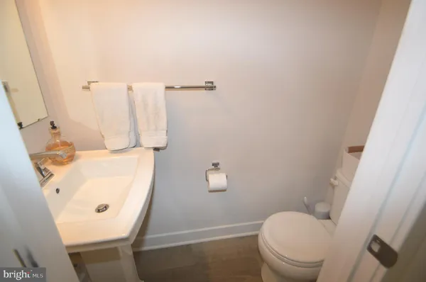 a bathroom with a sink toilet and mirror