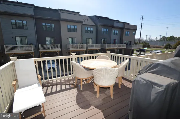 a view of a patio with table and chairs