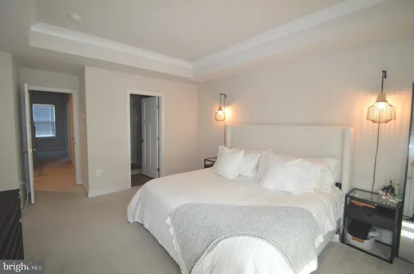 a bedroom with a bed and a lamp