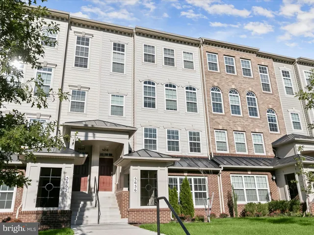 a front view of a residential apartment building with a yard