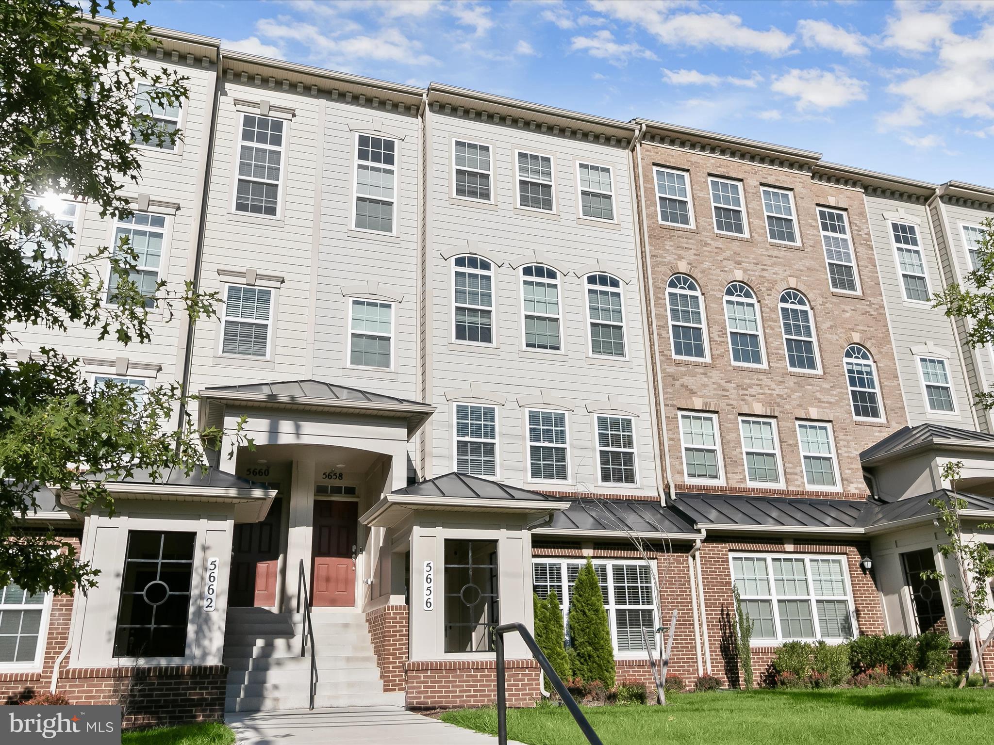 a front view of a residential apartment building with a yard