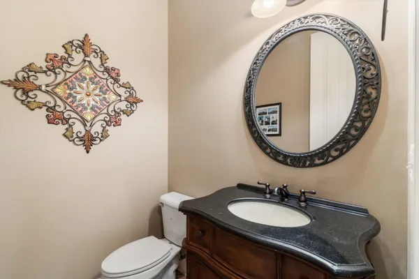 a spacious bathroom with a granite countertop double vanity and a mirror