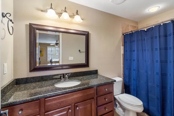 a view of a house with patio furniture and potted plants
