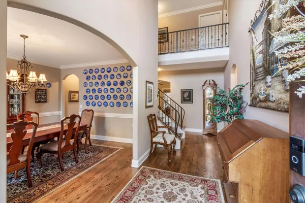 a view of an entryway wooden floor and livingroom