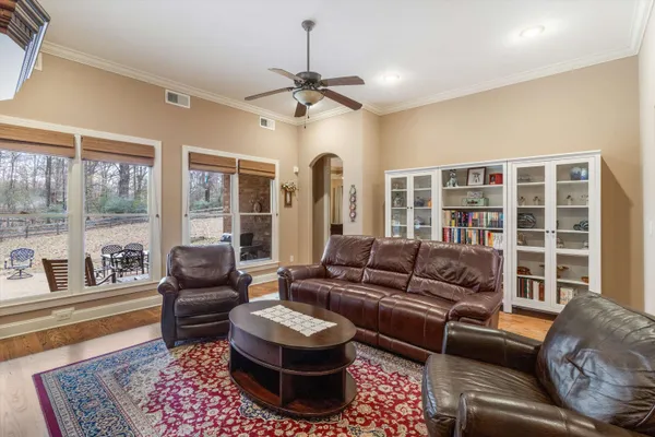 a living room with furniture and a wooden floor