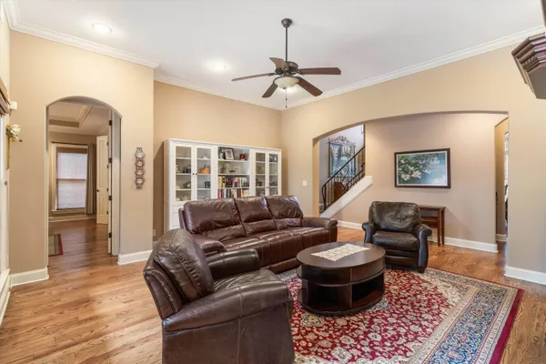 a kitchen with stainless steel appliances granite countertop a stove a sink a refrigerator a center island a dining table and chairs