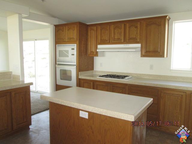 4763 Shannon View Road Acton, CA 93510 - Photo 5 of 24 a kitchen with a refrigerator and a stove top oven
