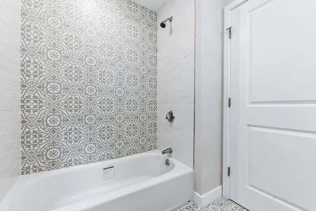 a bathroom with a bathtub and shower