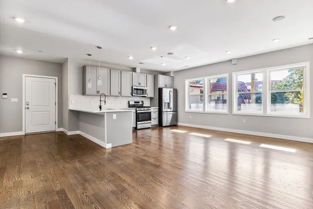 a view of kitchen with wooden floor and windows