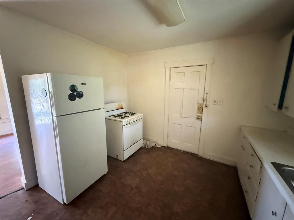 1724 McFerrin Avenue Waco, TX 76708 - Photo 5 of 11 a view of a storage & utility room with refrigerator