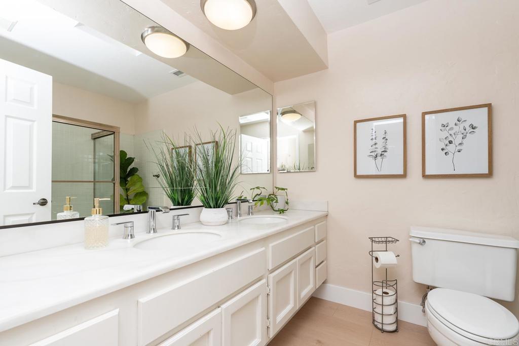 3913 Summer Way Escondido, CA 92025 - Photo 16 of 40 a bathroom with a double vanity sink toilet and mirror