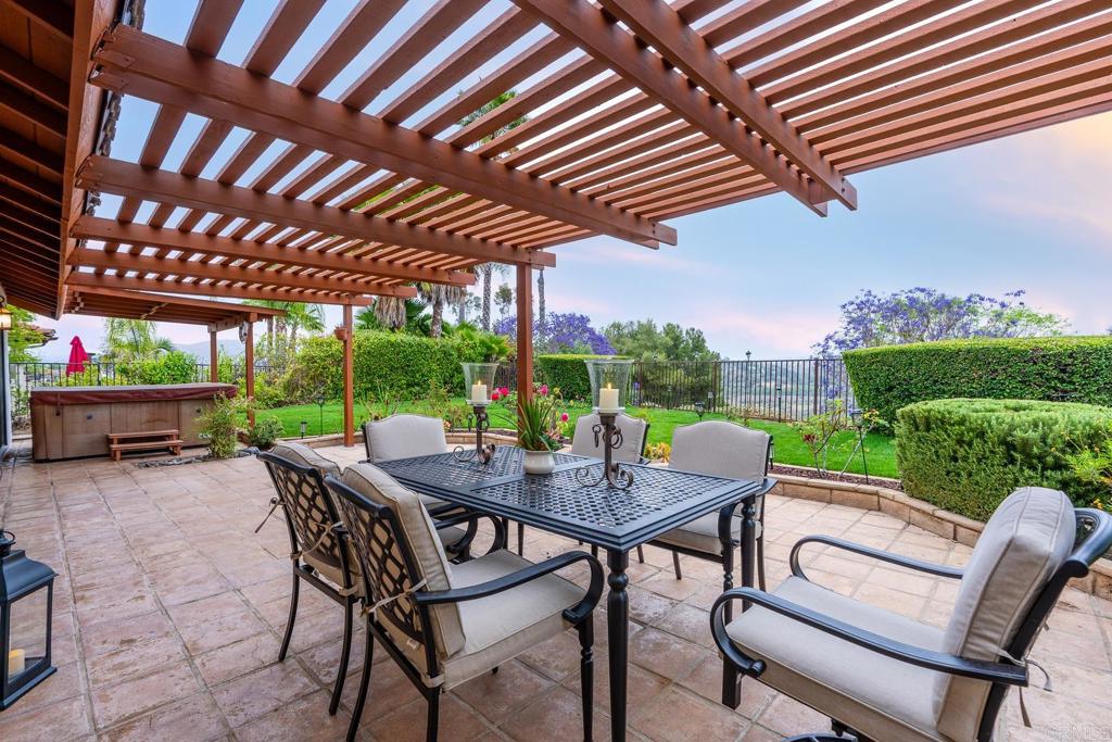 3913 Summer Way Escondido, CA 92025 - Photo 28 of 40 a view of a patio with table and chairs under an umbrella with a barbeque