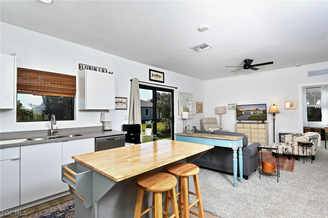 809 Bell Boulevard Lehigh Acres, FL 33974 - Photo 13 of 37 a large kitchen with a table and chairs