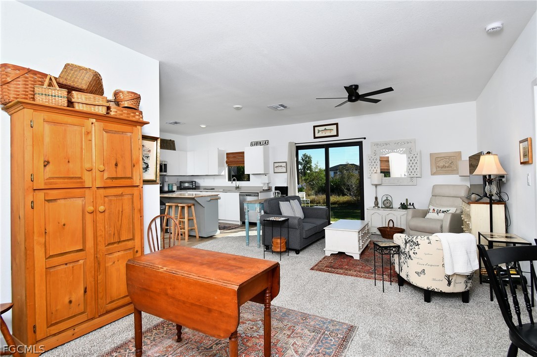 809 Bell Boulevard Lehigh Acres, FL 33974 - Photo 16 of 37 a living room with furniture a window and kitchen view
