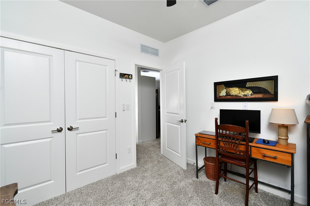 809 Bell Boulevard Lehigh Acres, FL 33974 - Photo 25 of 37 a view of a workspace with furniture and a window