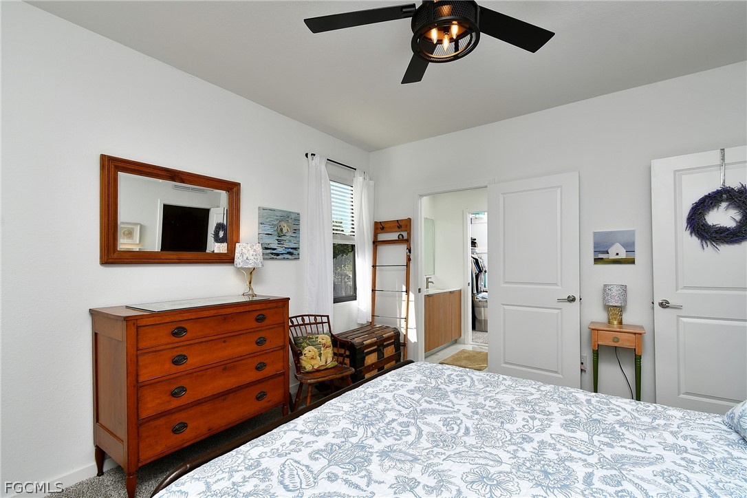 809 Bell Boulevard Lehigh Acres, FL 33974 - Photo 27 of 37 a bedroom with a bed and furniture